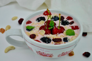 Smoothie Bowl with Cherries, Blueberries,Granola,Blackberries,Strawberries and Mint.Heath breakfast