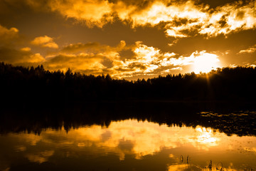 Landscape of autumn, sunset sky over lake in the forest, silhouette