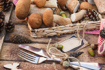 Raw white mushrooms, pine cones and decorative tag