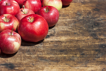 Red apples on old wooden table