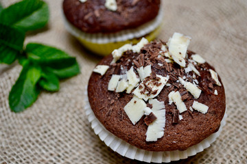 Fototapeta na wymiar Closeup of Chocolate Muffins on a Rustic Burlap Sack.