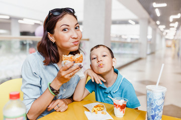 Mother And her son Having a fast food Lunch Together At The Mall