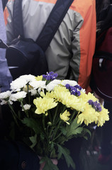 School boy with autumn bouquet of chrysanthemums