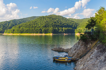 Amazing mountain lake Vidraru in Carpathian mountains at Romania, wild nature landscape in the summer