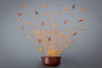 Dishes for eating with different types of spaghetti various forms near it. Food Concept. Components...