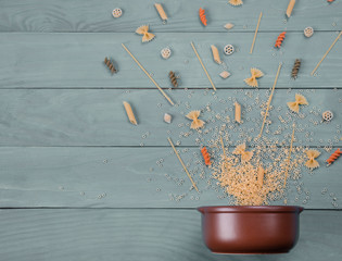 Dishes for eating with different types of spaghetti various forms near it. Food Concept. Components...