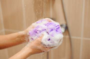 Fototapeta premium woman using a soap while taking shower in bathroom