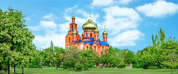 The Church of THE HOLY APOSTLES AND THE GOSPEL JOHN OF BOGHOSLOV in Pokrov city in Ukraire. Panorama of the holy Christian temple in the park in summer