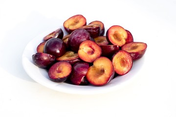 Purple plum with leaf isolated on white background with clipping path