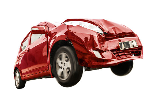 The Red Car Has Damaged The Front. Traffic Accident Of A Car Isolated On White Background. Flying Car With Broken Part From Crash.