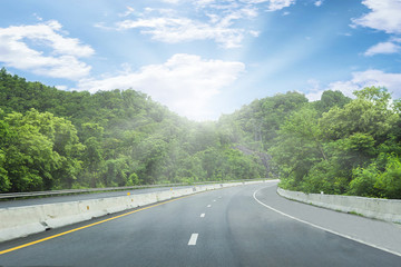 Beautiful highway road of Thailand with green mountain and blue sky background