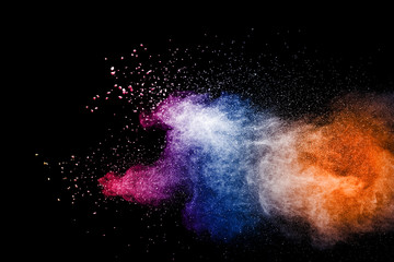 The explosion of multi colored powder. Beautiful powder fly away. The cloud of glowing color powder on white background