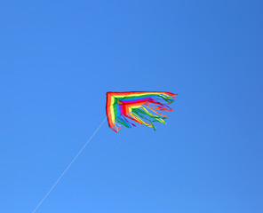 kite flying high in blue sky