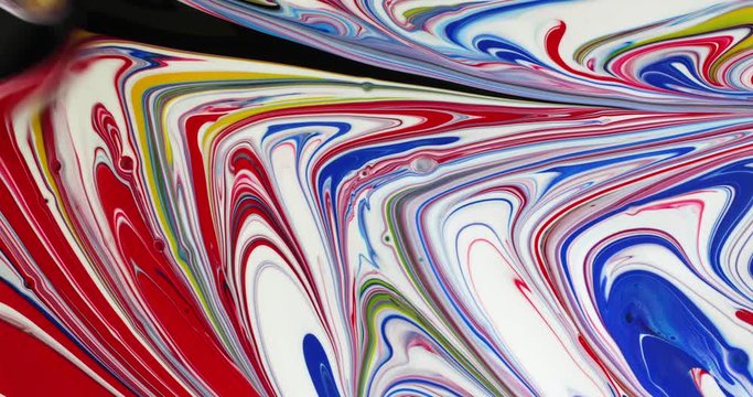 Colorful poster paint abstract painting with black being brushed into the design..