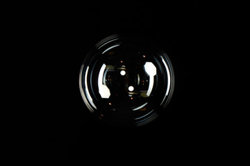 Big transparent soap bubble on black background