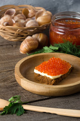 Sandwich salmon caviar wooden bowl butter greenery