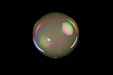 Soap bubble with gel inside on black background