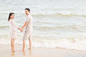 Fototapeta na wymiar Asian couple on beach