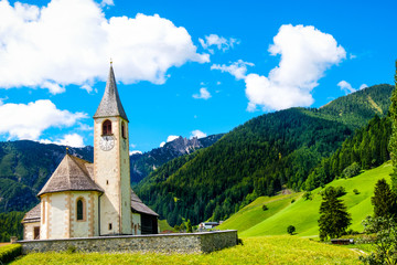 Fototapeta na wymiar Trentino Alto Adige mountain church postcard San Vito Braies Italy
