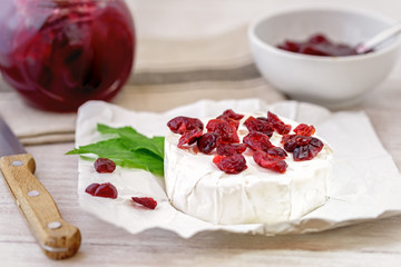 Dried cranberries on camembert cheese. 