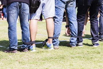 Five legged race outdoor party game, harmonious unity concept