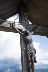 Naklejka premium More than 100 years old wooden crucifix, typical of Dolomites region, Italy