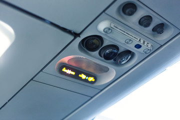 Fototapeta premium airplane cabin interior detail. No smoking and seat belt signal