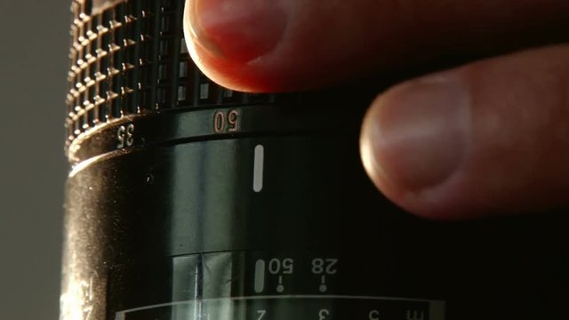 Fingers adjusting DSLR Lens & focus