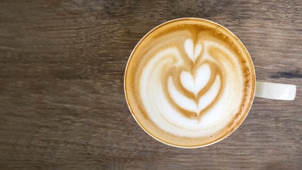 Hot coffee cappuccino latte art top view on wooden background