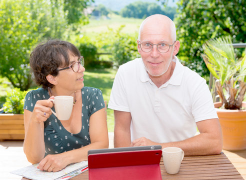 Mature Couple Drinking  Coffee On  Garden Terrace