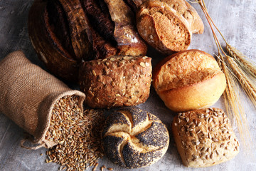 Different kinds of bread and bread rolls on board. Kitchen or bakery poster design.