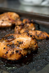 Roasted chicken on the grill pan macro. horizontal view from above