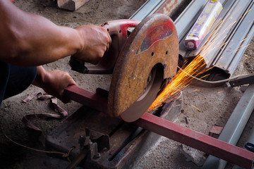 Worker use grinder to cut the tube.