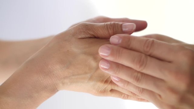 Massage of hands close up on a white background