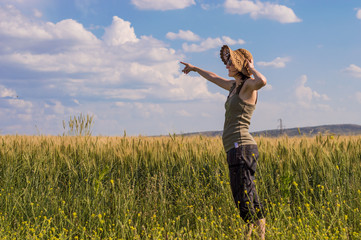 Young woman with hat enjoying the nature. Notice concept.