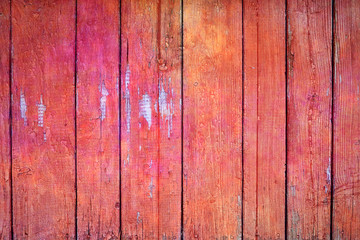 Wooden background in pastel orange. Old background painted fence of boards.