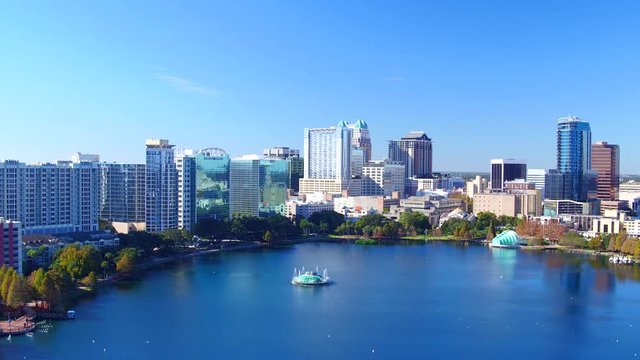 Orlando FL aerial Orlando Lake Eola in the morning with urban skyscrapers and clear blue sky trees