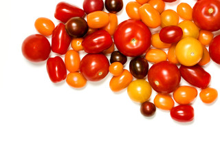 Pile of fresh multicolor heirloom tomatoes isolated on white