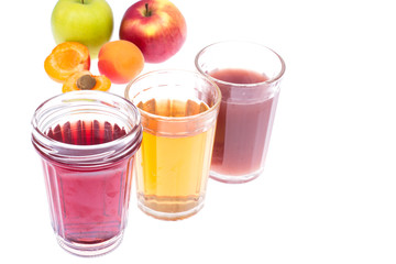 Three glass glasses with fresh fruit and berries juices