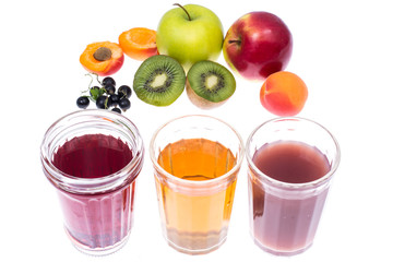 Three glass glasses with fresh fruit and berries juices