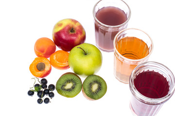 Three glass glasses with fresh fruit and berries juices