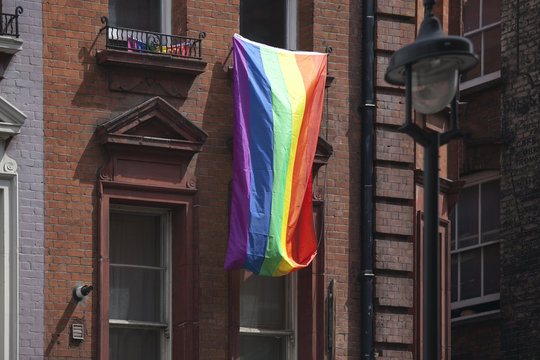 The rainbow flag is hung from the window in the Soho