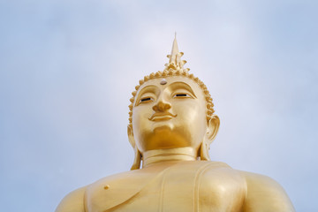 Fototapeta premium Buddha / View of statue of Buddha on blue sky background. Khao Kho, Phetchabun, Thailand.