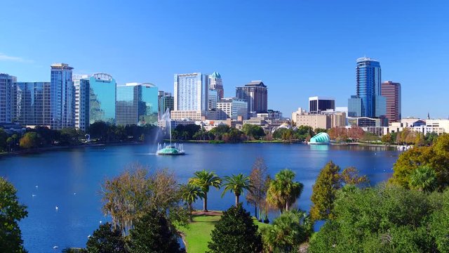 Orlando FL aerial Orlando Lake Eola in the morning with urban skyscrapers and clear blue sky trees