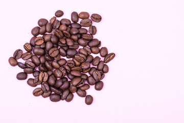 Black coffee beans on bright pastel background