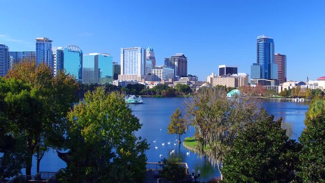 Orlando FL aerial Orlando Lake Eola in the morning with urban skyscrapers and clear blue sky trees