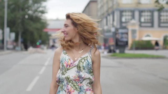 beautiful young blond woman walking around the city.slow motion