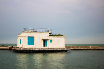 Lonely white building in the sea