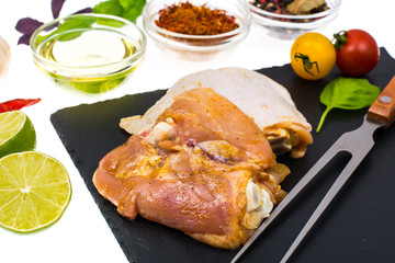 Plate with chunks of fresh chicken and seasonings