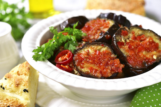 Eggplant slices in a spicy red sauce.